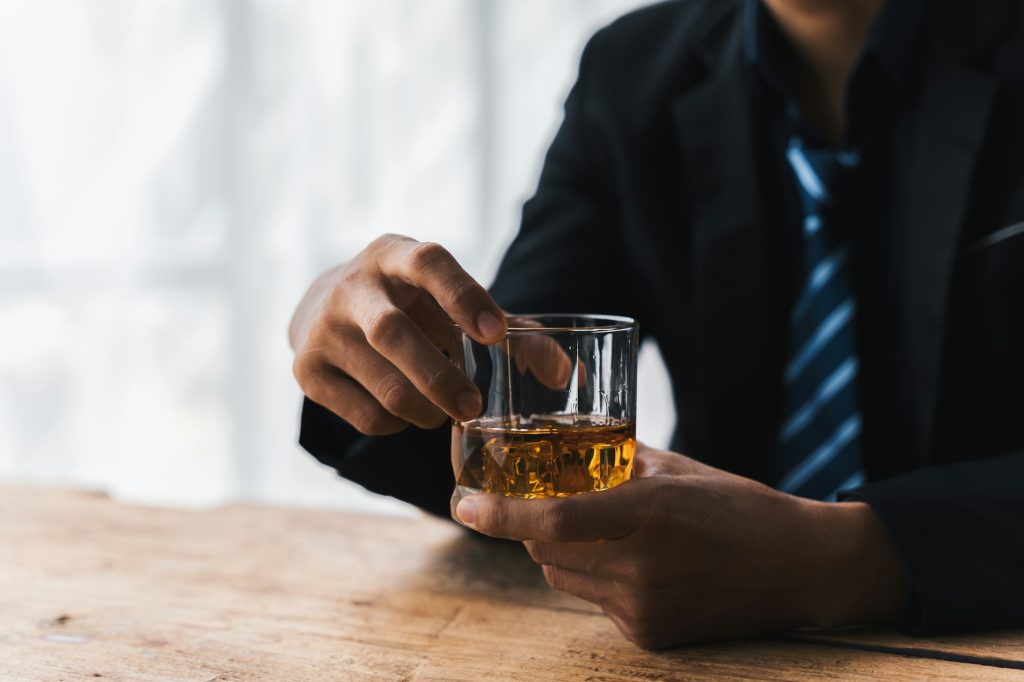 drunk asian man hold whisky glass addicted alcohol need therapy.