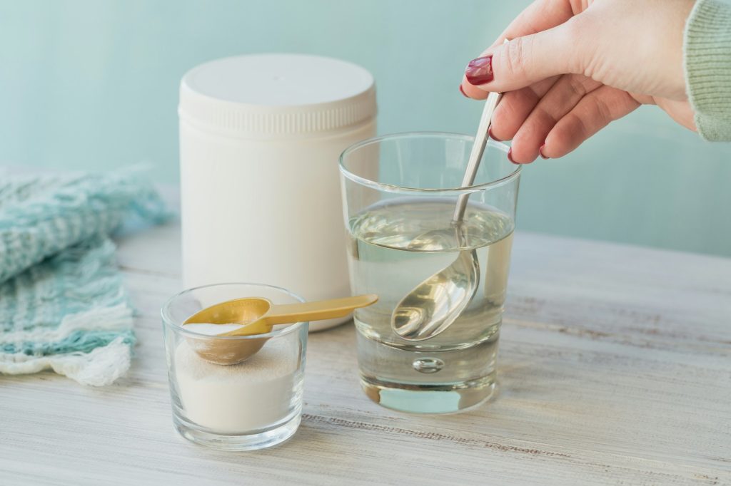 Glass with collagen dissolved in water and collagen protein powder
